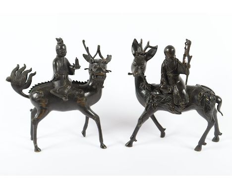 ZWEI FIGÜRLICHE WEIHRAUCHBRENNER, Bronze, je zweiteilig, Gottheiten mit ihren Attributen auf Begleittier reitend, H bis 33, b