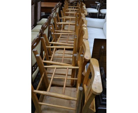 Twenty beech chapel chairs, curved top rail, crucifix pierced splat, hymnal shelf to back, bottoming to seat, double H stretc