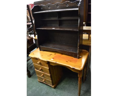 A modern pine desk, shaped rectangular top, kneehole with adjacent four drawer flight; an oak three shelf bookcase (2)