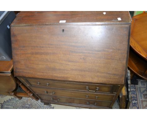 A mahogany three drawer bureau on bracket feet.