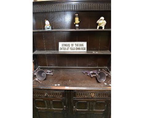 An Ercol style dresser, fluted frieze over shelving to top, two fluted front drawers over two panel door cupboard to base, st