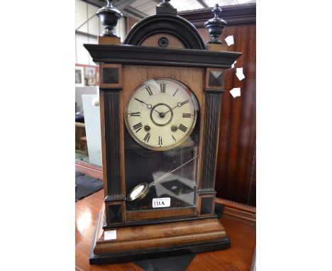 A Victorian walnut and ebonised mantel clock