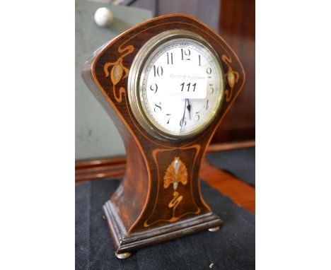 A mahogany inlaid Art Nouveau mantel clock