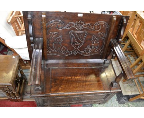 An early 20th century carved oak monk's bench, c.1930
