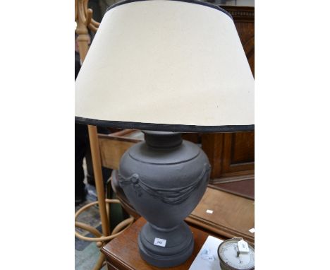 A large ceramic urn shaped table lamp with shade 