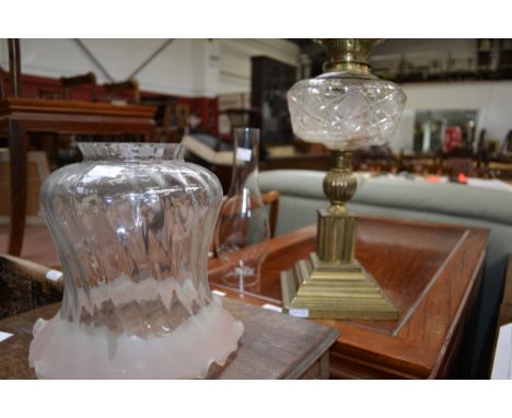 A Victorian oil lamp glass reservoir, Duplex double burner, brass column, stepped square base.