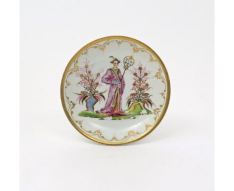 A Meissen Böttger porcelain saucer  c.1722, hausmaler decorated with a single standing chinoiserie figure holding a shaped fa