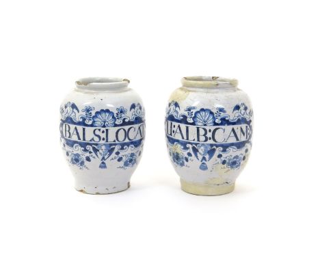 A pair of English delftware dry drug jars  mid 18th century, each painted in blue with an oval cartouche surmounted by cherub