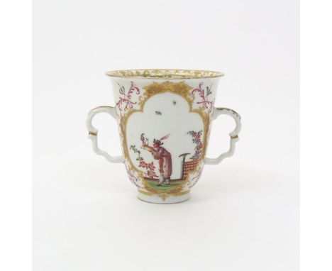 A Meissen two-handled beaker  c.1723, the tall flared form painted to each side with a quatrefoil panel, one with a Chinaman 