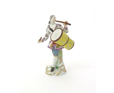 A Meissen figure of a drummer  1st half 20th century, a long yellow drum suspended from a strap over one shoulder, playing th