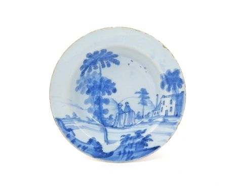 A Bristol delftware bowl of unusually small size  c.1750-70, painted in blue with two ladies in full skirts standing beneath 