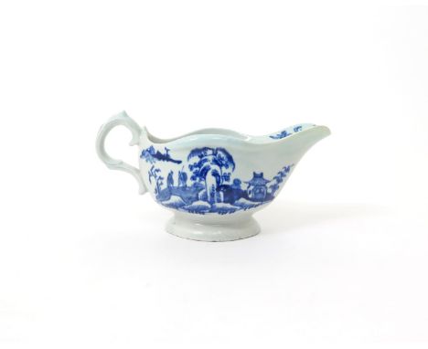 A Vauxhall blue and white sauceboat  c.1755-60, painted in bright blue with two Chinese figures conversing beneath willow iss