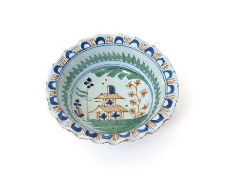 A Bristol delftware powder bowl or basin  c.1720-30, moulded with a pie crust edge, painted to the interior with a two-storey