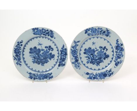 A pair of large Dublin delftware plates  c.1760, probably Delamain's World's End Pottery, painted with flowering peony and ch