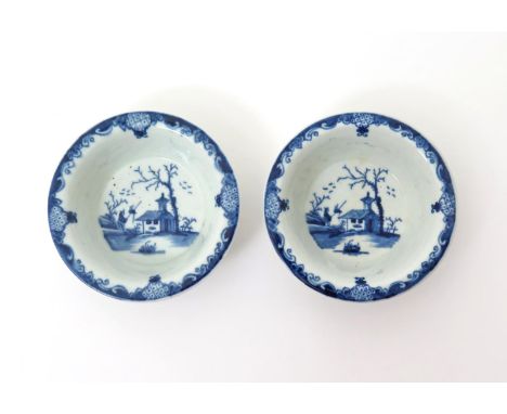 A pair of Worcester blue and white patty pans  c.1758-60, painted with the Bare Tree and Speared Bird pattern, each with a Ch