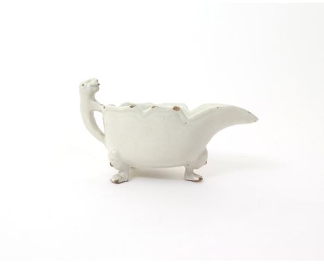 A rare white-glazed English delftware sauceboat  mid 18th century, probably Bristol or Liverpool, the generous form raised on