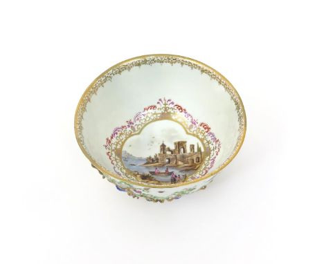 A Meissen bowl  c.1745, painted to the interior with a scene of figures in boats at a quayside within a quatrefoil panel, the