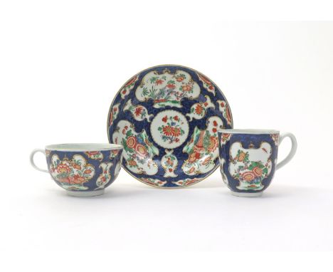 A good Worcester trio  c.1770, comprising a teacup, coffee cup and saucer, brightly decorated with panels of Oriental flowers