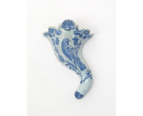 A Liverpool delftware wall pocket  c.1760, of cornucopia form, moulded and decorated in blue with a bird perched on a floweri