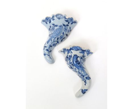 A near pair of Liverpool delftware wall pockets  c.1760, each formed as a cornucopia, moulded and painted in blue with a sing