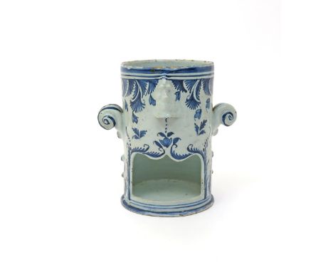 A London delftware food warmer base  c.1760-80, the cylindrical form with a shaped opening beneath a moulded mask, a further 