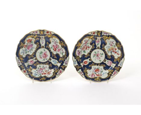 A good pair of Worcester plates  c.1770, decorated in the atelier of James Giles with shaped panels of flower garlands edged 