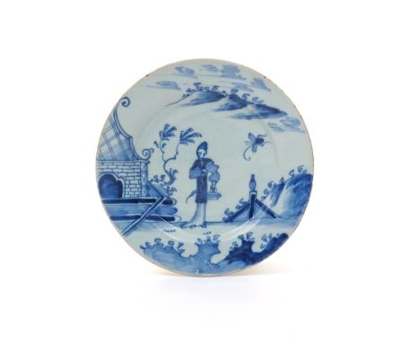 An English delftware plate  mid 18th century, Bristol or Wincanton, painted in blue with a central standing Chinese figure be