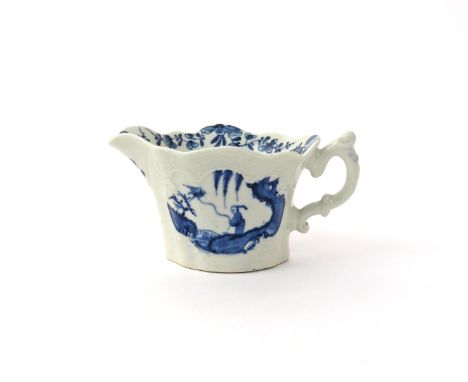 A Worcester blue and white creamboat  c.1755, each side moulded with a shaped panel beneath an arched osier border, painted w
