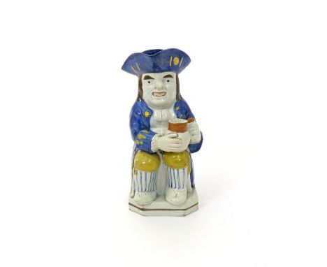 A pearlware Toby jug  c.1800, of Ordinary type, dressed as a sailor with blue striped stockings under yellow breeches, his bl