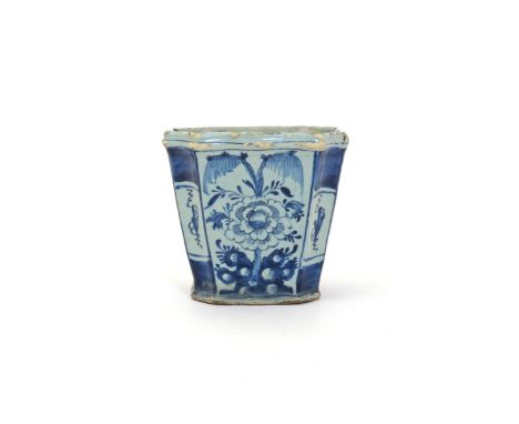 A delftware flower pot  mid 18th century, possibly English, of flared square form with chamfered corners, painted in blue to 