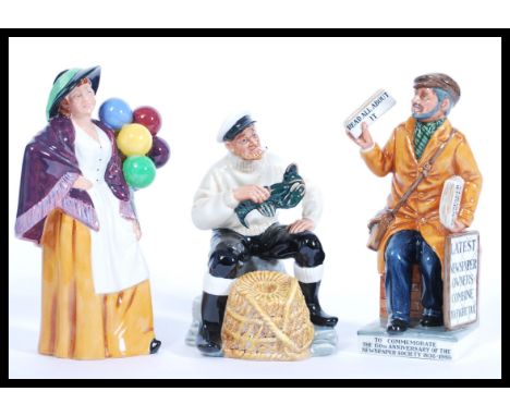 A collection of 3 Royal Doulton ceramic figurines to include The Balloon seller HN 2935, The Lobster Man HN 2323 and The News
