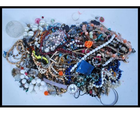 A selection of vintage costume jewellery to include a good selection of beaded necklaces, brooches, clip on earrings, a selec