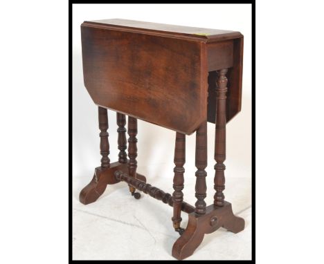 A Victorian mahogany Sutherland table being raised on ring turned legs with drop leaves raised on gate leg action&nbsp;