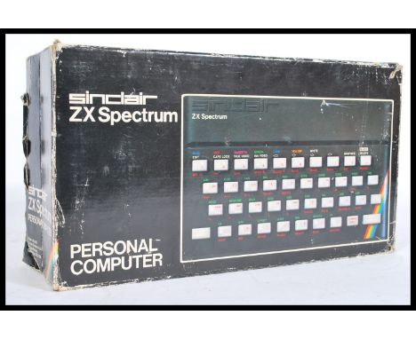 An original vintage Sinclair ZX Spectrum Personal Computer games console with 16K ram appearing complete within the original 