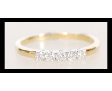 A stamped 18ct gold ring set with five diamonds. Weight 2.3g. Size O.5. Approx 20pts.&nbsp;