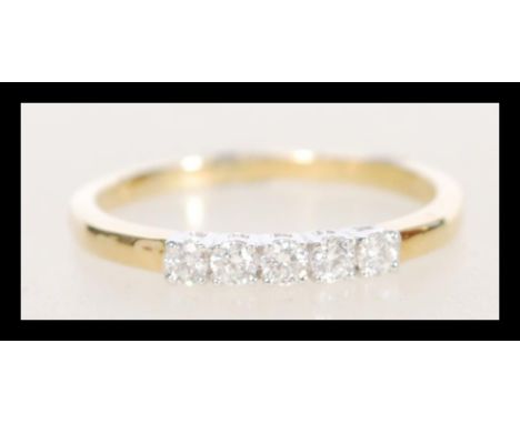 A stamped 18ct gold ring set with five diamonds. Weight 2.3g. Size O.5. Approx 20pts.&nbsp;