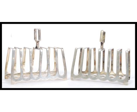 A pair of early 20th Century silver plated toast racks by Howson Brothers of graduating architectural form. Measures 12cm hig