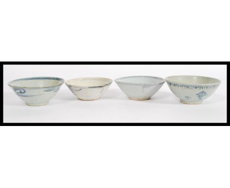 A group of four late 18th Century / early 19th Century Chinese ceramic bowls having white glaze painted with blue fish. Bigge