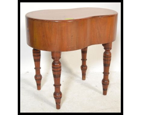 A Victorian 19th century kidney shaped mahogany bidet being raised on turned legs complete with the cover having a kidney sha