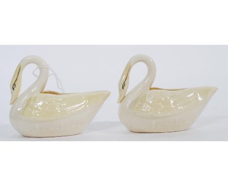 A pair of vintage 20th century Belleek ceramic creamer jugs in the form of swans. Green printed marks to base.