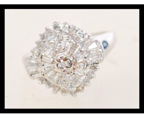 A 9ct white gold Art Deco style cluster ring having approx 50pts of diamonds in a typical Art Deco setting. Weighs 3.9 grams 