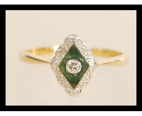 A stamped 18ct gold ring having a rhombus shaped enamelled panel set with a central round white stone and white accent stones