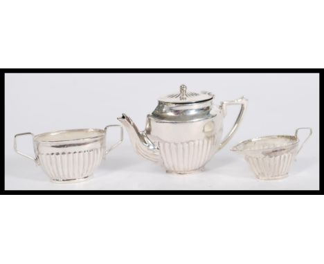 A stamped sterling silver doll's house miniature tea service to include teapot, sugar bowl and creamer. Weight 23.5g. 3.5cm h