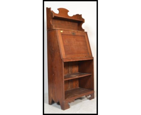A late 19th century oak arts &amp; crafts student bureau in the manner of Liberty &amp; Co. The fall front bureau with fully 