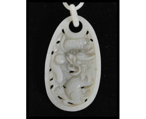 A Chinese hand carved Devil's Work jade necklace and pendant of long form with large panel pendant depicting birds of paradis