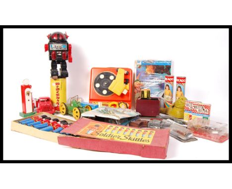 A collection of assorted vintage toys to include; 1045 Dinky Kit, Chad Valley soldier skittles, Limit tin plate gun, cap guns