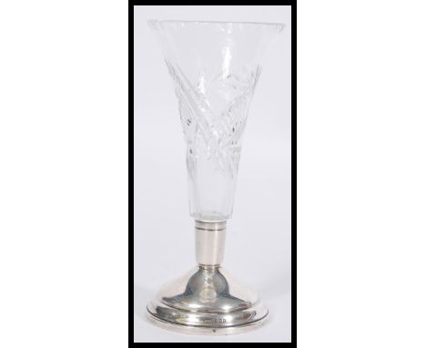 A vintage 20th Century silver hallmarked based cut glass vase raised on a stepped circular base with trumpet glass stem. Hall