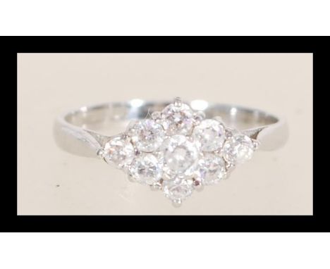 A hallmarked 9ct white gold cluster ring set with seven brilliant cut white stones. Hallmarked Birmingham 2000. Weight 1.7g. 