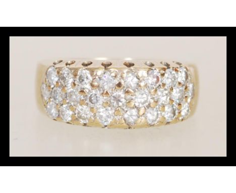 A hallmarked 9ct gold diamond ring having three rows of brilliant cut diamonds. Diamonds total approx 75pts. Total weight 4.8