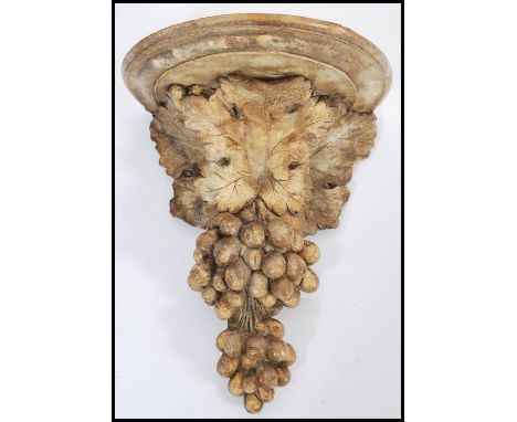 A 20th Century cast composite antique style wall bracket / mount in the form of grapes and vine leaves having a semi circular